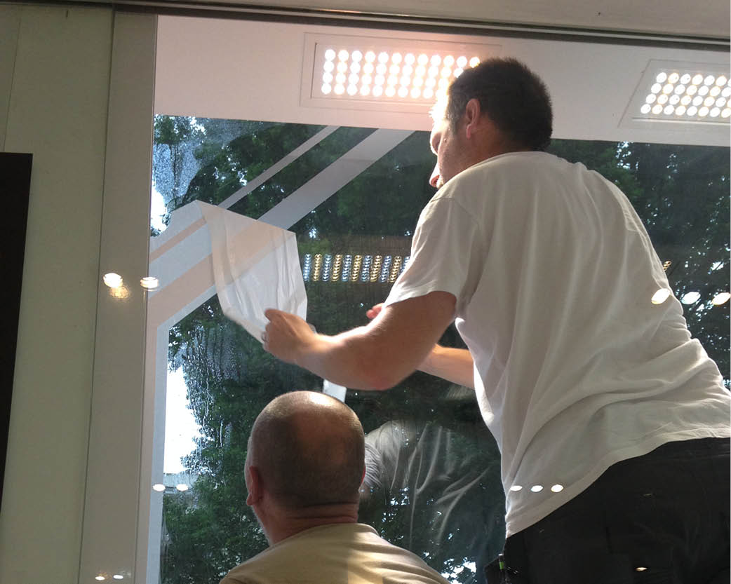 A picture of a people installing retail window graphics